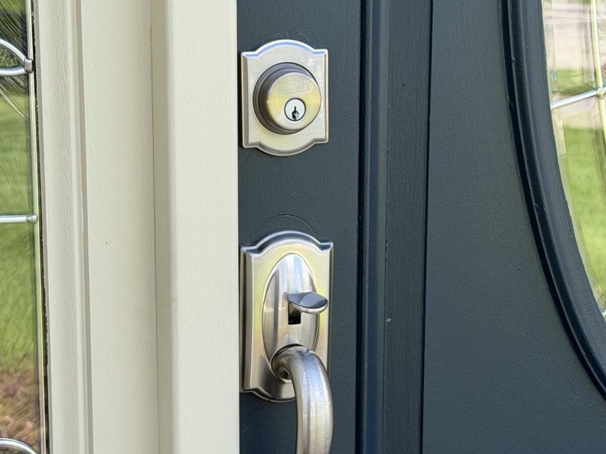 Locksmith rekeying a front door deadbolt